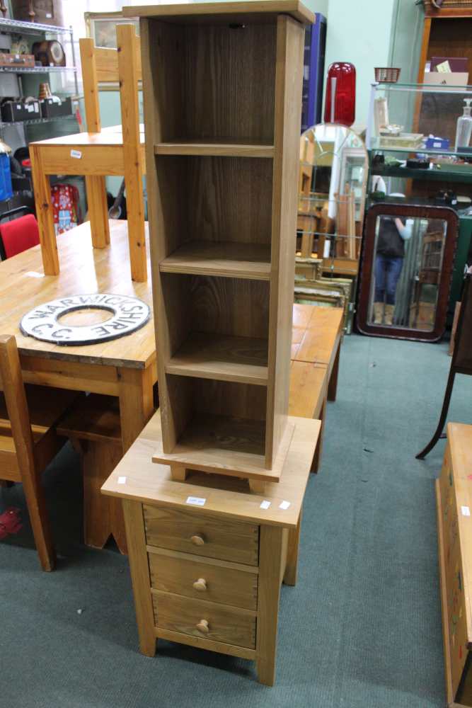 A modern oak 3 draw bed side chest together with a DVD storage tower