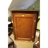 A 19th century oak large size hanging cupboard with inlaid shell motif