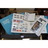 Three pale blue albums, together with a bag of stamps & small green book of stamps