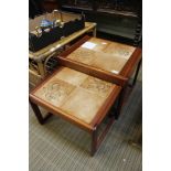 A pair of tile top nesting tables