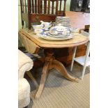 A modern pine twin flap kitchen table, single baluster column on four outswept legs.