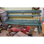A metal framed green painted slatted garden bench