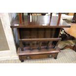 A wooden, mobile, table top Canterbury unit with singe storage drawer.