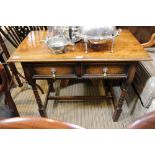 A reproduction oak side table with two inline draws on turned and blocked four legs