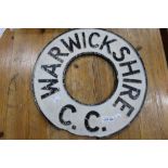 A painted cast metal Warwickshire county council sign