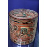 A 20th century Burmese lacquered food container, cylindrical box containing two inner bowls, red, bl