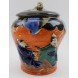 A Japanese Sumeda pottery lidded jar, with typical moulded figures