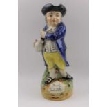 A Victorian Staffordshire "Hearty good fellow" toby jug typically standing with pipe and foaming ale