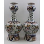 A pair of polychromed Delft pottery vases