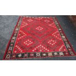 A 20th century Kilim carpet, red ground with all-over stylised motifs