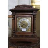 A wood cased mantle clock