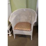 A white Lloyd Loom armchair