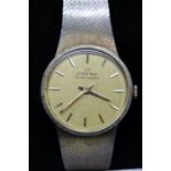 A gold plated Omega branded bracelet wristwatch, having plain baton dial,