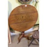 A 19th Century oak tri-pod tilt top table