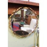 A circular fancy gilt framed Atsonea bevel plate wall mirror