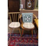 Three Ercol design chairs, one single, one carver, and a rocker