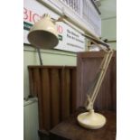 A cream angle-poise lamp