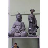 A seated meditive Buddha together with a Geisha figurine