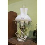 A chromed based table lamp with milk glass shade