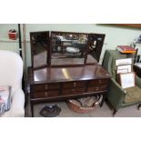 A stag brown dressing table with triple mirror back