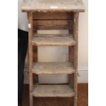 A small three-step set of vintage wooden ladders
