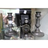 A Brownie box camera, together with a pair of probable 18th century pewter candlesticks