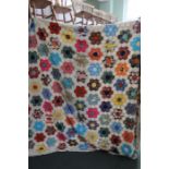 A double bed sized traditional patchwork quilt, of individual hexagonal fabrics