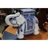 An Oriental pottery white elephant garden seat, with trunk up