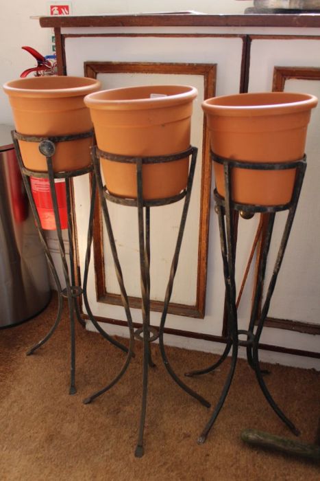 Three freestanding planters on metal stands