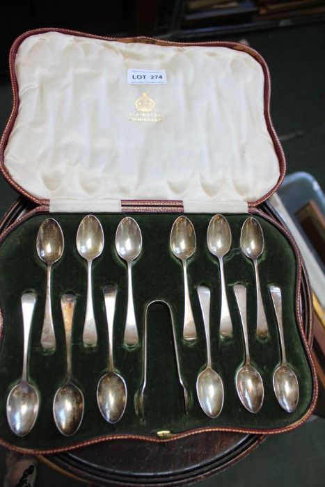 A cased set of twelve Elkington silver spoons, and sugar nips in fitted case