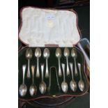 A cased set of twelve Elkington silver spoons, and sugar nips in fitted case