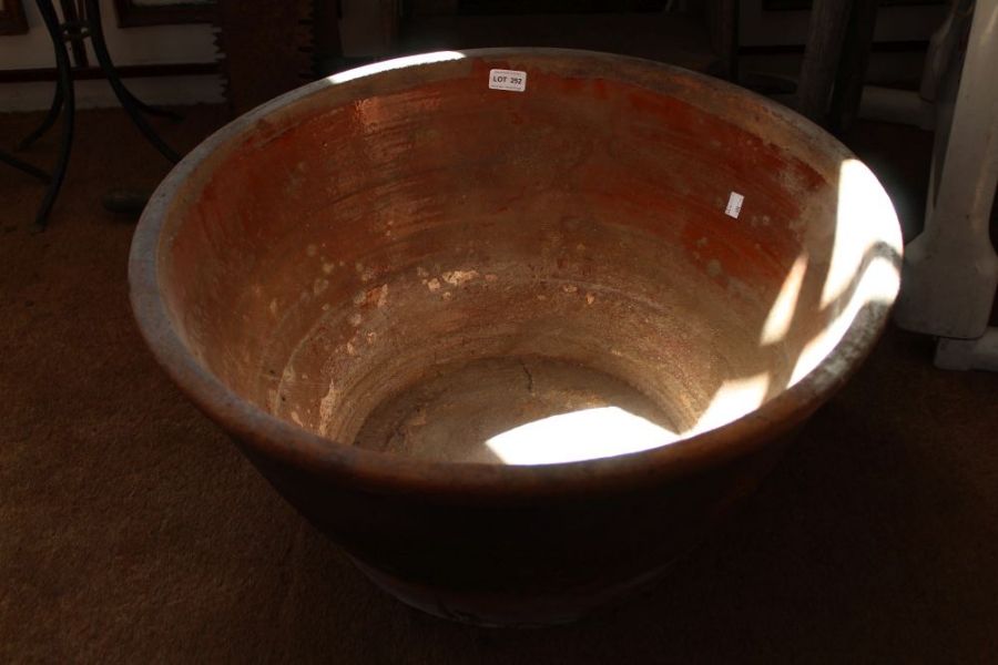 A large terracotta dairy bowl