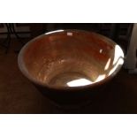 A large terracotta dairy bowl
