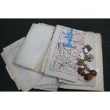 A selection of military maps together with seven metal cap badges