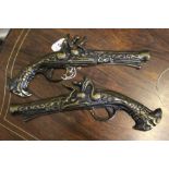 A pair of cast brass pistols