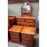 A dark pine chest of drawers & pair of bedside chests, together with a mirror