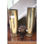 Two vintage brass artillery shell cases, together