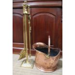 A copper coal scuttle and a brass companion set