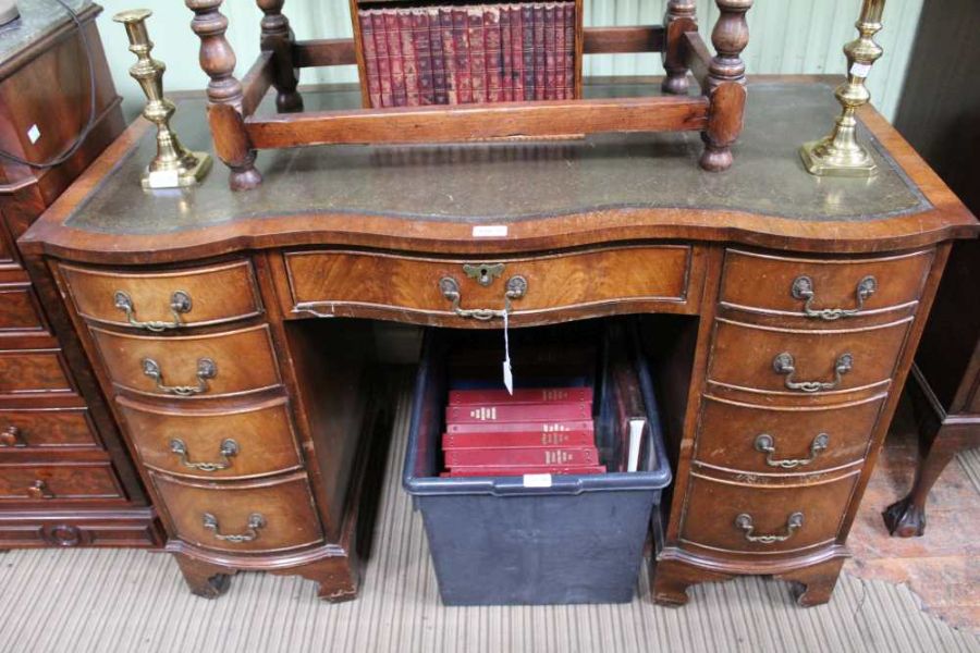 A mahogany serpentine fronted pedestal desk with insert leather top