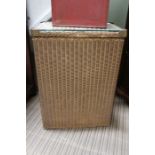 A gold painted Lloyd Loom laundry basket