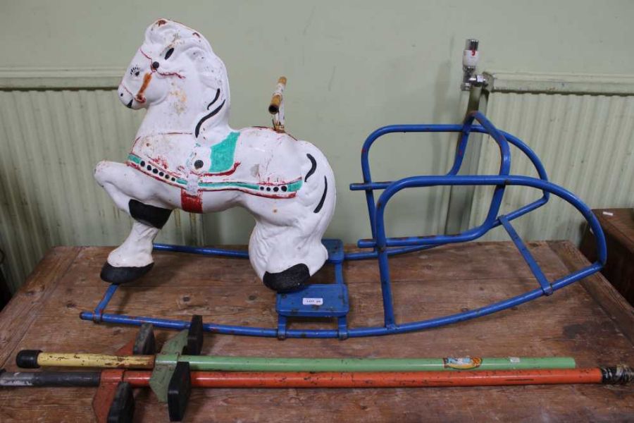 A metal rocking horse, together with two Pogo stic