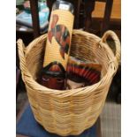 A well woven wicker twin handled basket, together with two carved wooden mask wall hangings