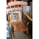 A late 19th century beech spindle back country kitchen armchair, with elm seat