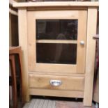 An oak side cupboard with glazed door & single drawer