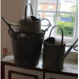 Two vintage galvanized watering cans, together with an egg preserving pail