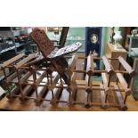 A soft wood wine rack and a carved Quaran stand