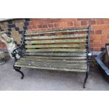 A cast metal wooden slatted garden bench, 130cm
