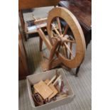 A modern beech manual spinning wheel with accessories