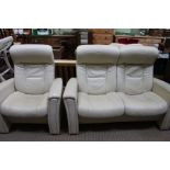 An ivory leather upholstered manually reclining two-piece suite