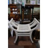 A cream painted neoclassical design stool with bergère seat, together with a slat back chair, and a